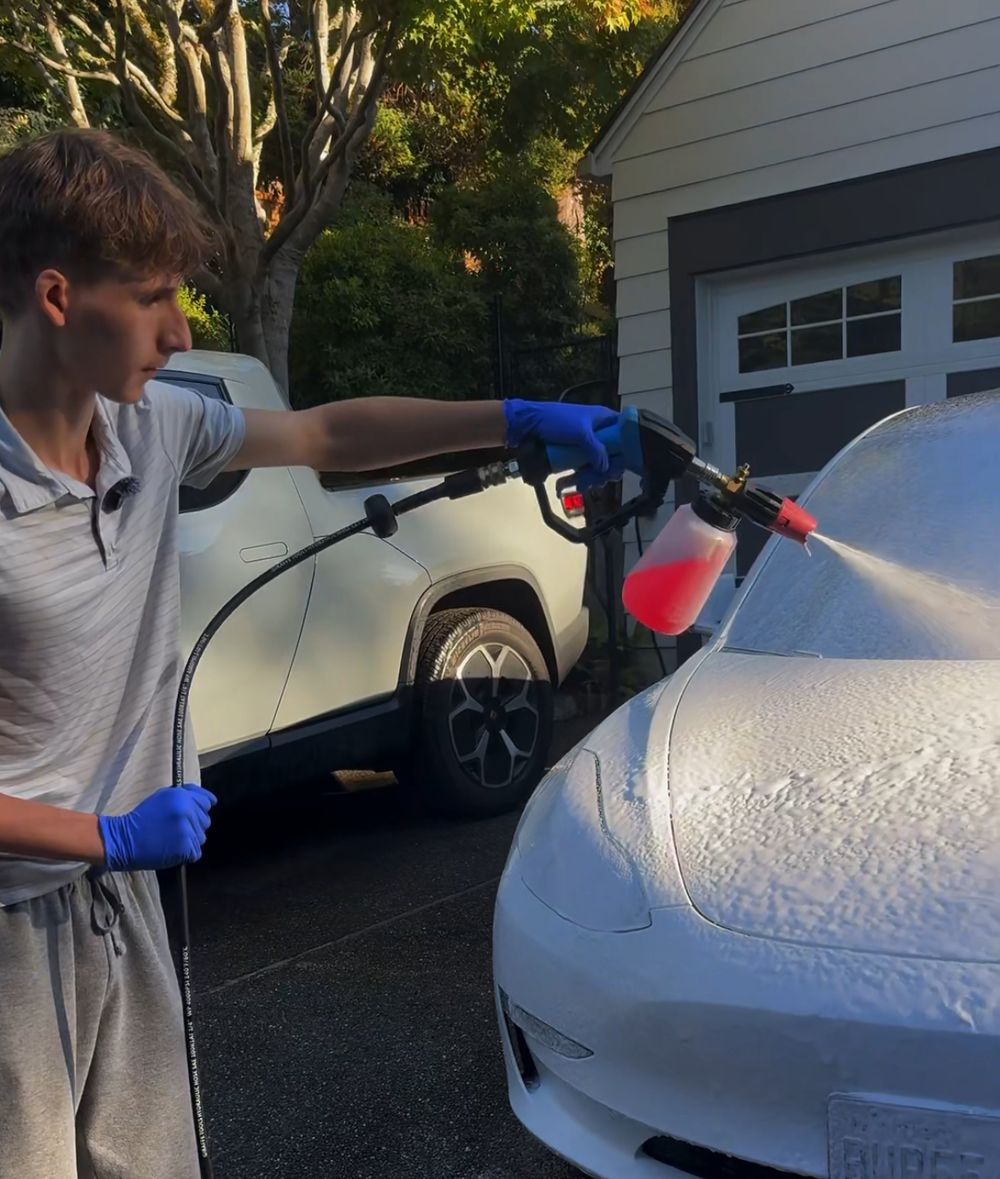 Remy Denhez foam-washing a white car